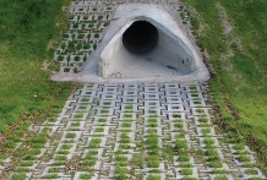ArmorLoc concrete interlocking block protecting a culvert from erosion. 